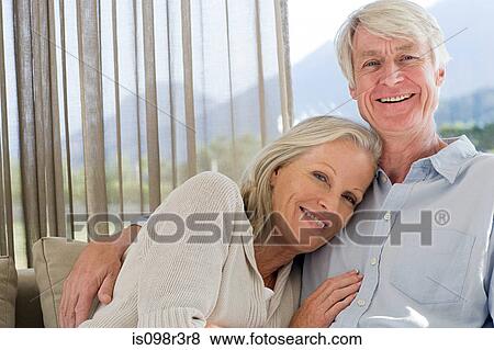 Middle aged couple relaxing on couch together View Large Photo Image Stock Photo - Middle aged couple relaxing on couch together. Fotosearch