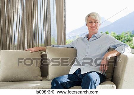 Portrait of middle aged man sitting on couch View Large Photo Image Stock Image - Portrait of middle aged man sitting on couch. Fotosearch