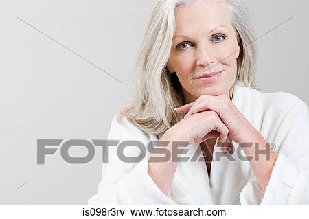 Stock Photo - Portrait of Middle aged woman wearing bathrobe. Fotosearch