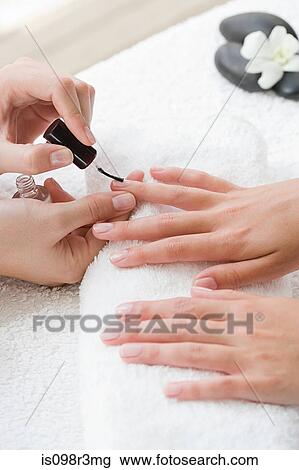 Woman getting nails polished during manicure View Large Photo Image Stock Image - Woman getting nails polished during manicure. Fotosearch
