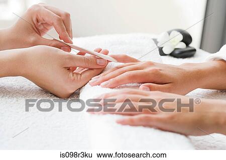 Woman receiving manicure View Large Photo Image Stock Photograph - Woman receiving manicure. Fotosearch