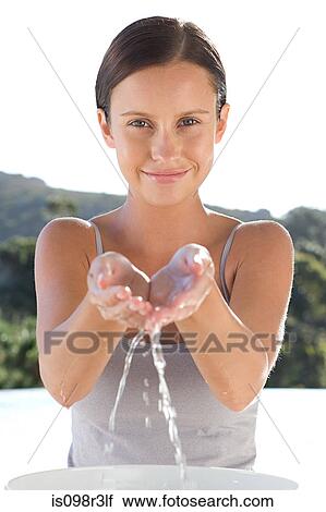 Young Woman Cupping Water In Hands Stock Image Is098r3lf Fotosearch