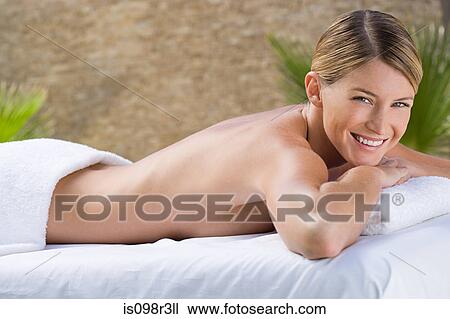 Stock Image - Young woman lying on massage table. Fotosearch