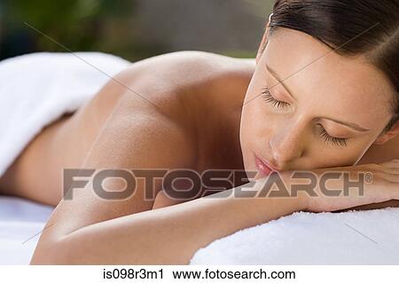 Stock Image - Young woman lying on massage table. Fotosearch