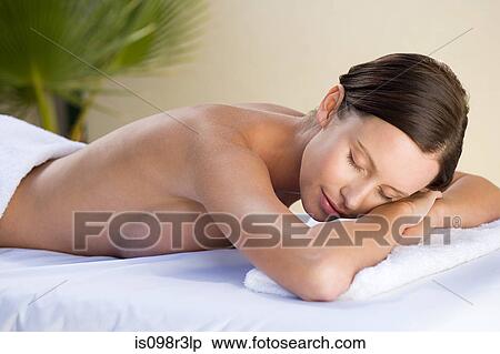 Stock Photography - Young woman lying on massage table. Fotosearch