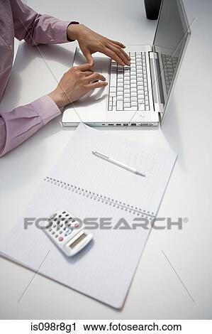 Cropped image of a businesswoman at desk View Large Photo Image Stock Image - Cropped image of a businesswoman at desk. Fotosearch