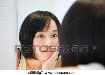 Japanese woman looking in the mirror View Large Photo Image Stock Photo - Japanese woman looking in the mirror. Fotosearch