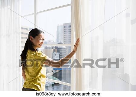 Japanese woman looking through a window View Large Photo Image Stock Photo - Japanese woman looking through a window. Fotosearch