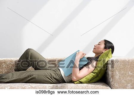 Stock Photograph - Japanese woman sleeping on sofa. Fotosearch
