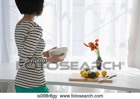 Stock Photo - Japanese woman standing at window. Fotosearch
