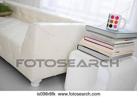Sofa and a stack of books View Large Photo Image Stock Image - Sofa and a stack of books. Fotosearch