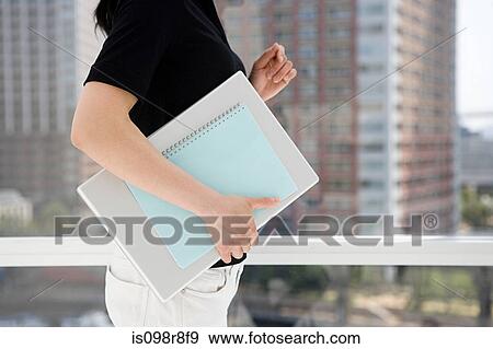Woman holding notebook and documents View Large Photo Image Stock Photo - Woman holding notebook and documents. Fotosearch