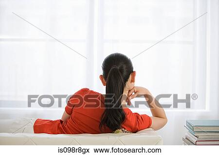 Woman relaxing on sofa View Large Photo Image Stock Photo - Woman relaxing on sofa. Fotosearch