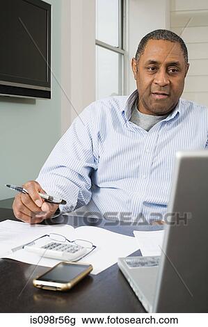 Man doing home finances View Large Photo Image Stock Image - Man doing home finances. Fotosearch