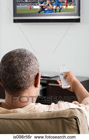Man watching television View Large Photo Image Stock Photography - Man watching television. Fotosearch