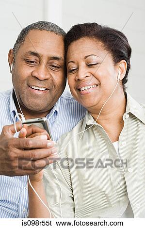 Mature couple sharing mp3 player View Large Photo Image Stock Photograph - Mature couple sharing mp3 player. Fotosearch