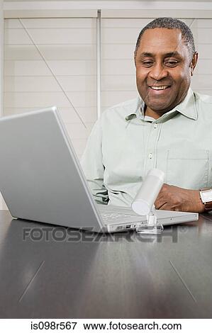 Mature man using webcam View Large Photo Image Stock Photo - Mature man using webcam. Fotosearch