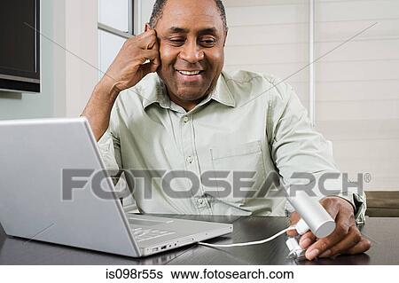 Mature man using webcam View Large Photo Image Stock Photograph - Mature man using webcam. Fotosearch