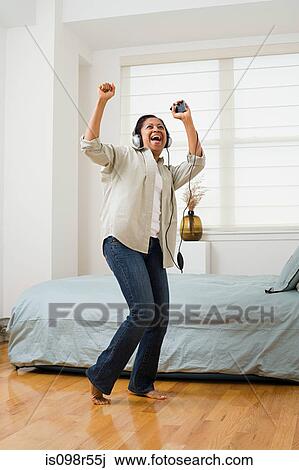 Woman listening to music and dancing View Large Photo Image Stock Image - Woman listening to music and dancing. Fotosearch