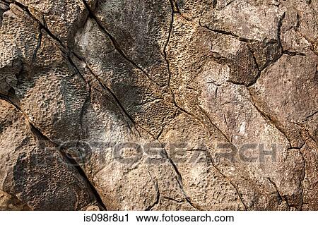 Stock Image - Close up image of cracked rocks. Fotosearch