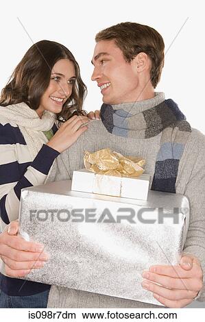 Happy couple holding gifts View Large Photo Image Picture - Happy couple holding gifts. Fotosearch