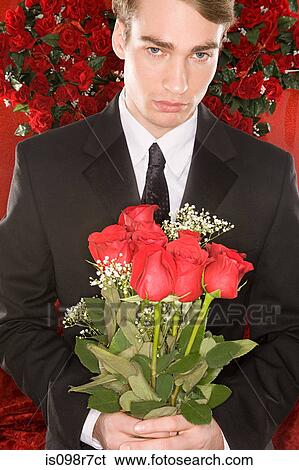 Stock Photograph - Man holding a bunch of roses. Fotosearch
