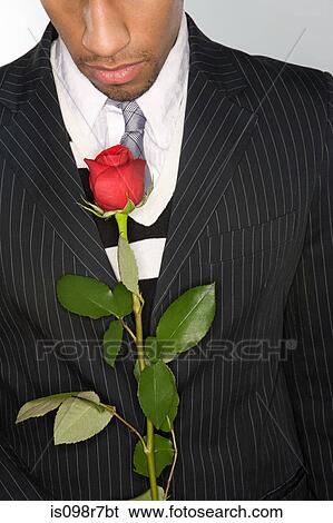 Stock Photograph - Man holding a red rose. Fotosearch