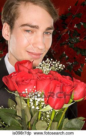 Romantic man with a bunch of roses View Large Photo Image Stock Photography - Romantic man with a bunch of roses. Fotosearch