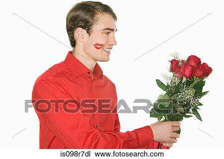 Smiling man holding a bunch of roses View Large Photo Image Stock Image - Smiling man holding a bunch of roses. Fotosearch