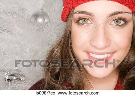 Picture - Smiling woman and christmas tree. Fotosearch