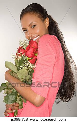 Stock Photo - Woman holding a bunch of roses. Fotosearch