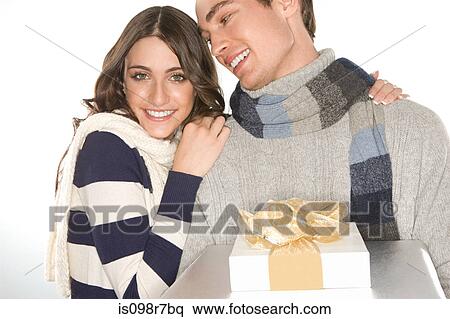 Young couple holding gifts View Large Photo Image Stock Photography - Young couple holding gifts. Fotosearch