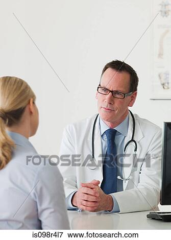 Stock Photo - Doctor and patient talking. Fotosearch