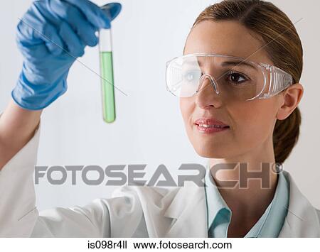 Female scientist holding a test tube View Large Photo Image Stock Image - Female scientist holding a test tube. Fotosearch