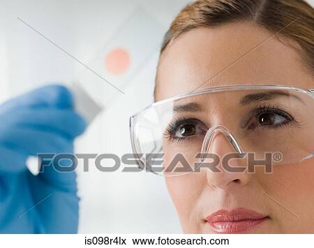 Female scientist holding litmus paper View Large Photo Image Stock Photo - Female scientist holding litmus paper. Fotosearch