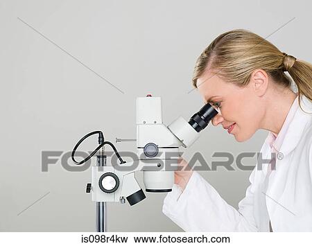 Female scientist using a microscope View Large Photo Image Stock Photo - Female scientist using a microscope. Fotosearch
