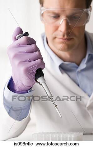 Stock Image - Male scientist doing an experiment. Fotosearch
