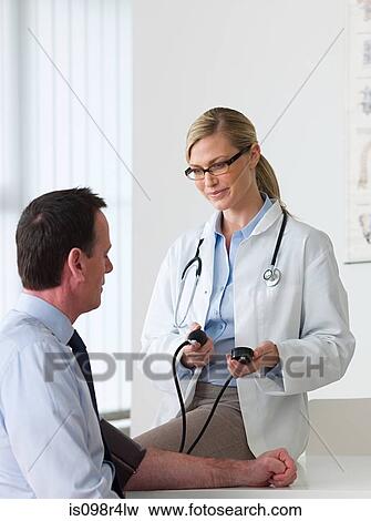 Man having a check up with doctor View Large Photo Image Stock Photo - Man having a check up with doctor. Fotosearch
