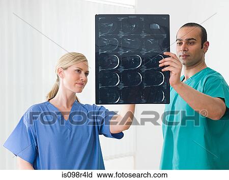 Stock Image - Medical colleagues holding an xray. Fotosearch