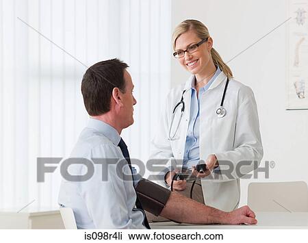 Stock Image - Patient with a female doctor. Fotosearch