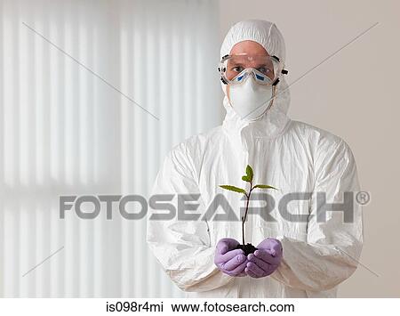 Scientist holding a plant View Large Photo Image Stock Image - Scientist holding a plant. Fotosearch