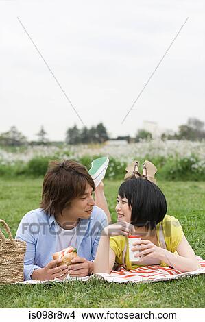 Couple having lunch on the grass View Large Photo Image Picture - Couple having lunch on the grass. Fotosearch