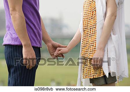 Stock Image - Couple holding hands. Fotosearch