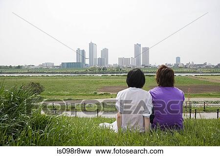 Stock Photo - Couple looking at city skyline. Fotosearch