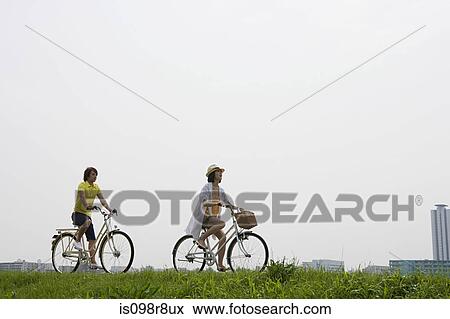 Young couple cycling View Large Photo Image Stock Photo - Young couple cycling. Fotosearch