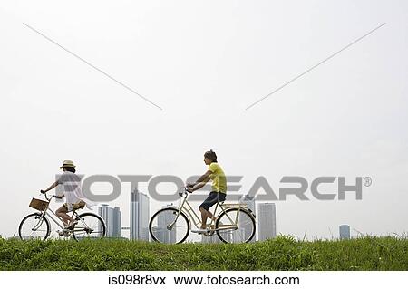 Stock Photo - Young couple cycling. Fotosearch