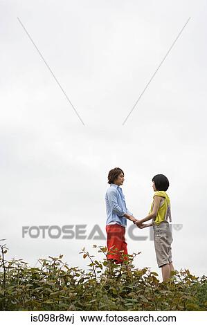 Young couple holding hands View Large Photo Image Stock Image - Young couple holding hands. Fotosearch