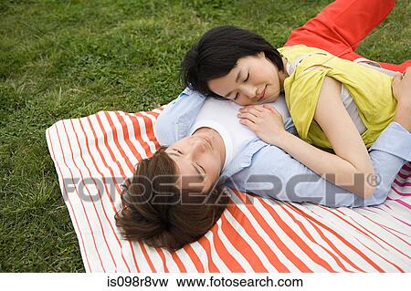 Young couple lying on blanket View Large Photo Image Stock Photo - Young couple lying on blanket. Fotosearch