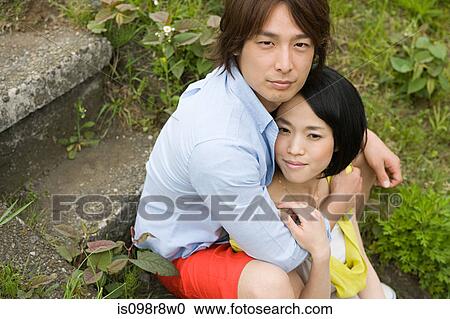 Stock Image - Young couple sitting on steps. Fotosearch
