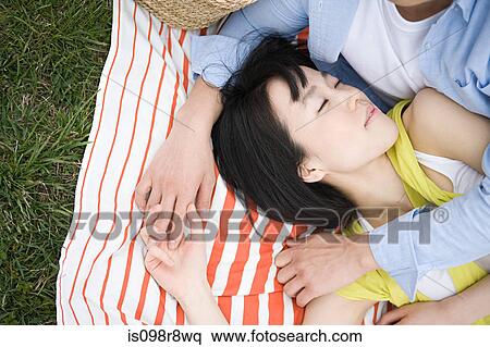 Young couple sleeping on blanket View Large Photo Image Stock Photography - Young couple sleeping on blanket. Fotosearch